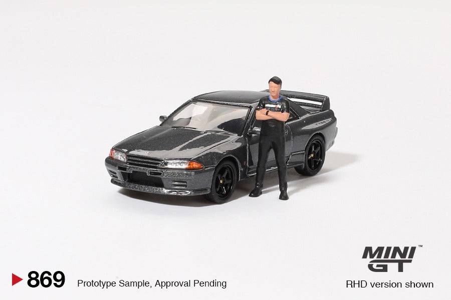 PRE-ORDER MINI GT 1:64 Nissan Skyline GT-R R32 Nismo Gunmetal W/ Matsuda Figure Tsugio Matsuda Collection MGT00869-R