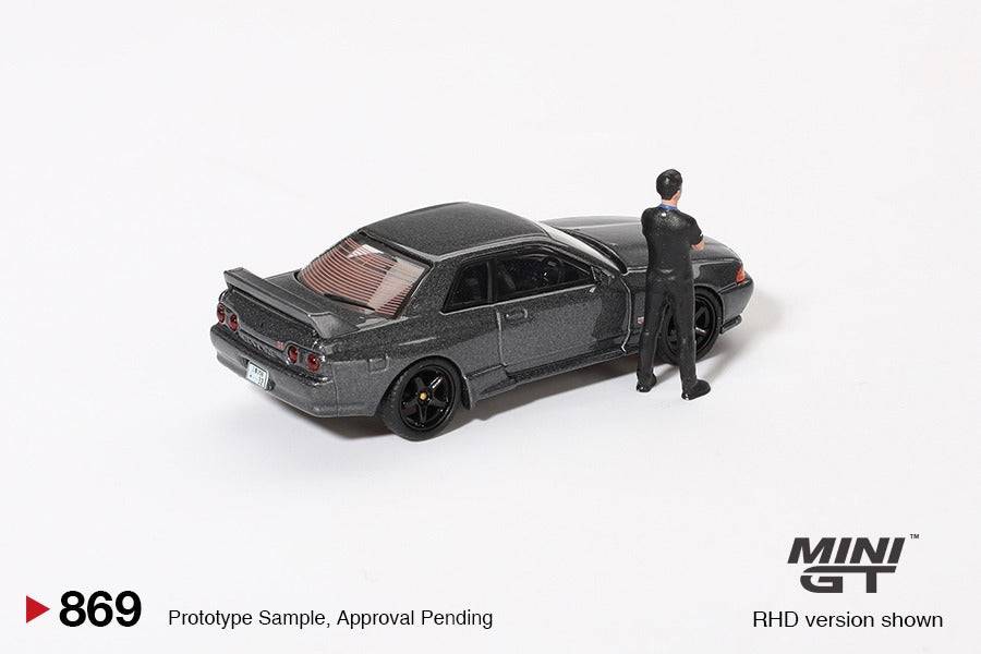 PRE-ORDER MINI GT 1:64 Nissan Skyline GT-R R32 Nismo Gunmetal W/ Matsuda Figure Tsugio Matsuda Collection MGT00869-R