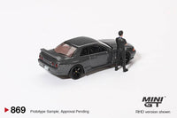 Thumbnail for PRE-ORDER MINI GT 1:64 Nissan Skyline GT-R R32 Nismo Gunmetal W/ Matsuda Figure Tsugio Matsuda Collection MGT00869-R