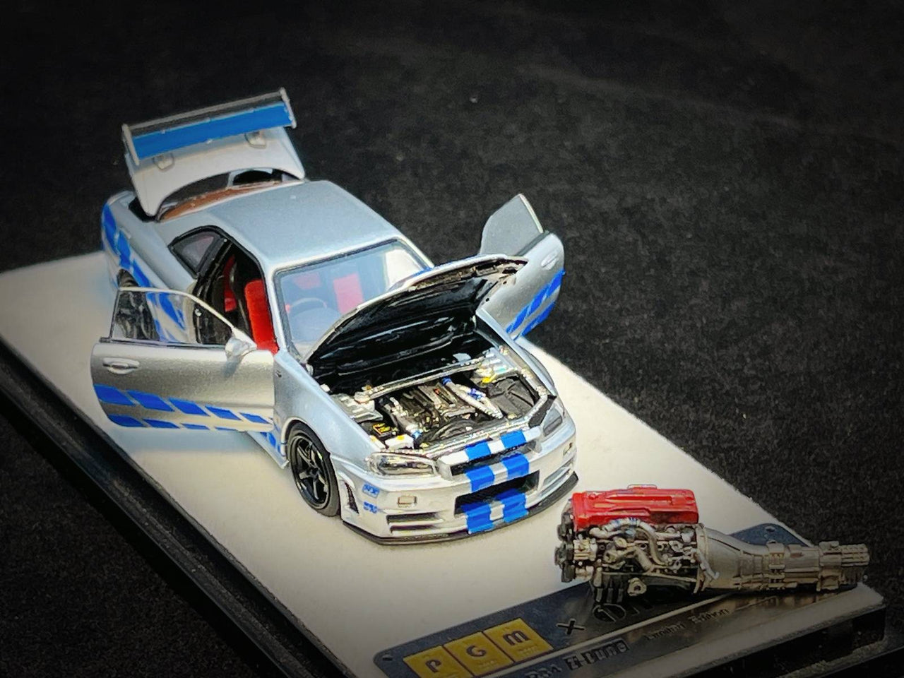 PRE-ORDER PGM 1:64 Nissan GT-R R34 Z-Tune Silver W/ Blue Stripe PAUL WALKER